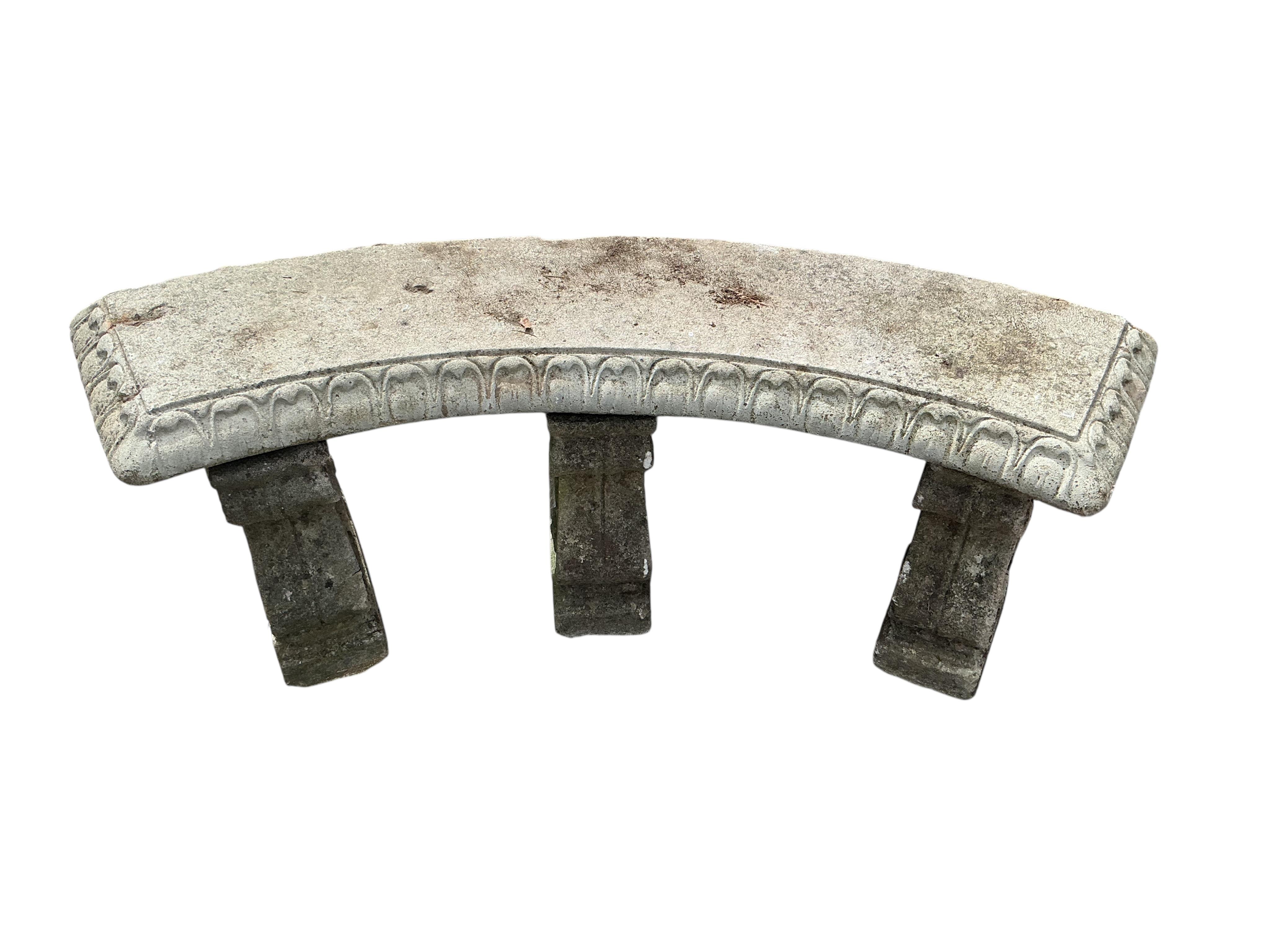 A reconstituted stone curved garden bench, width 134cm, height 44cm